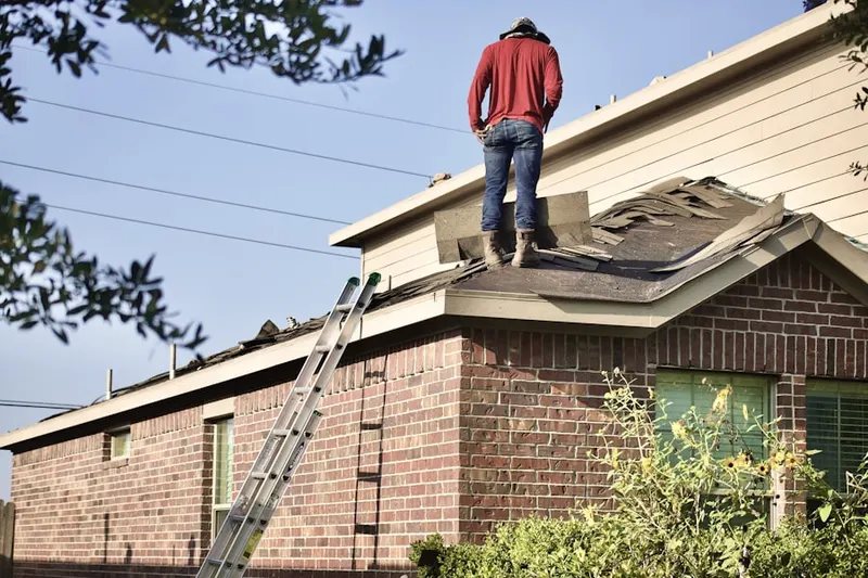 Professional roofer working on a residential roof in Vail